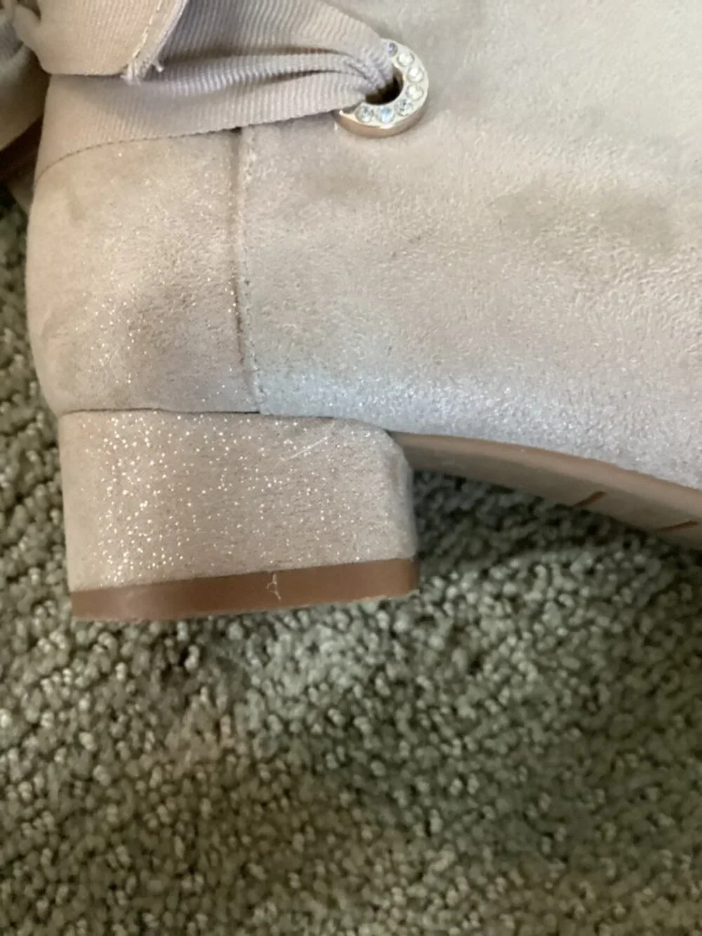 Heels for kids with bow on back of shoe.